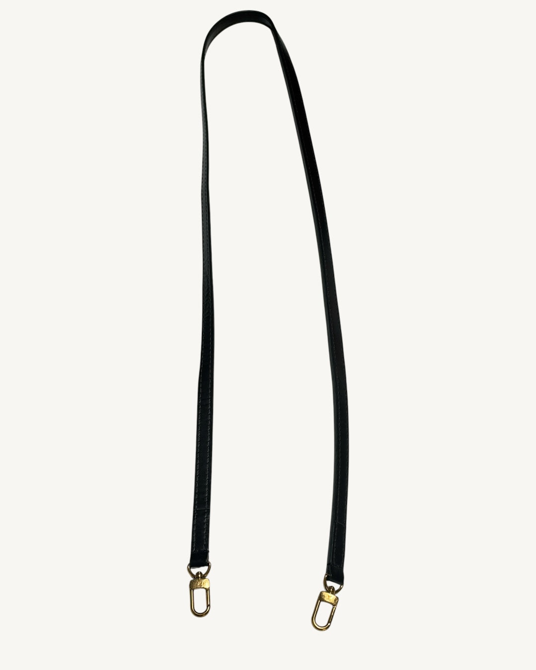 Louis Vuitton Clapton Backpack — Full removable brown leather strap laid out with both gold-tone swivel clasps