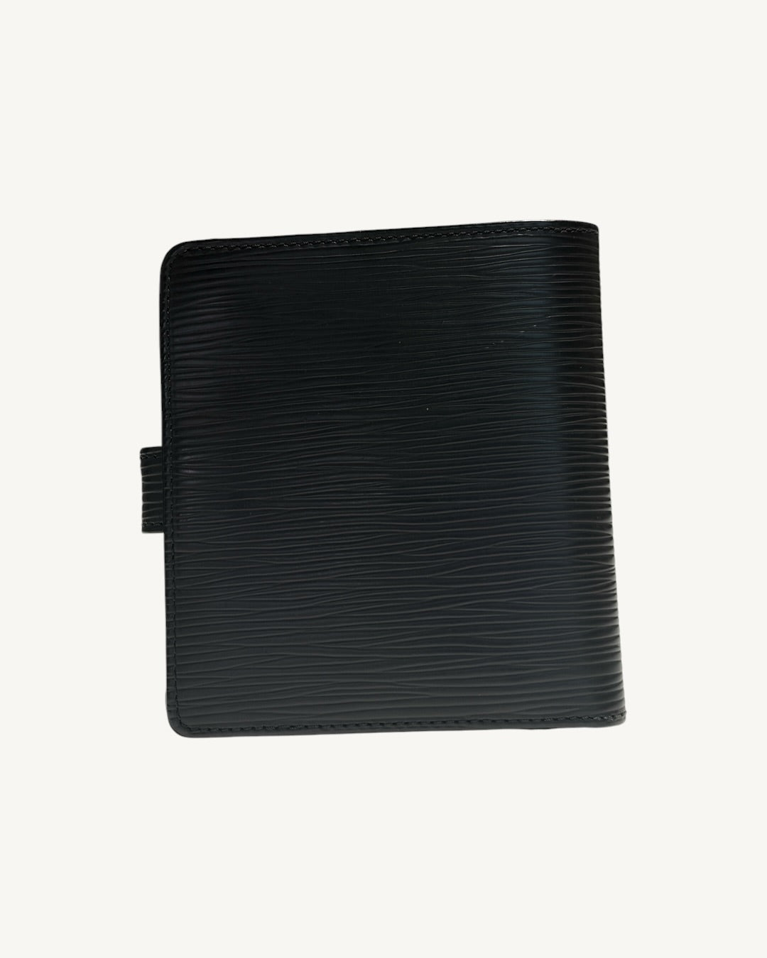Back of Louis Vuitton compact wallet showing black Epi leather and stitched edges