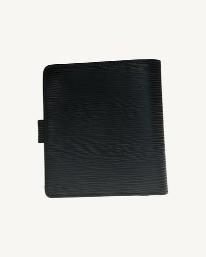 Back of Louis Vuitton compact wallet showing black Epi leather and stitched edges