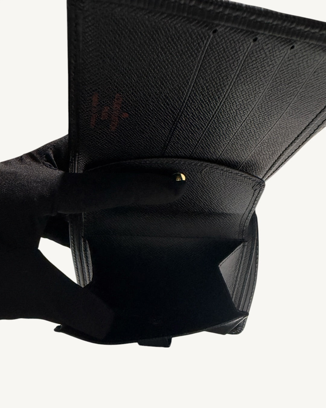 Open snap-button coin pocket and card slots inside Louis Vuitton black leather wallet