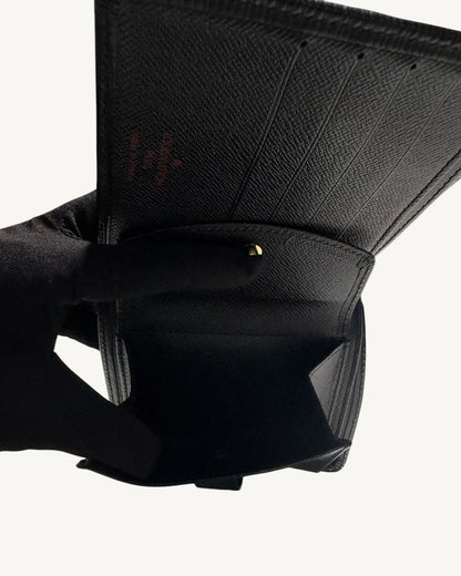 Open snap-button coin pocket and card slots inside Louis Vuitton black leather wallet