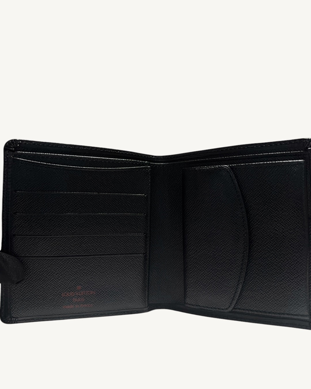 Open Louis Vuitton black leather bifold wallet showing card slots and closed coin pocket