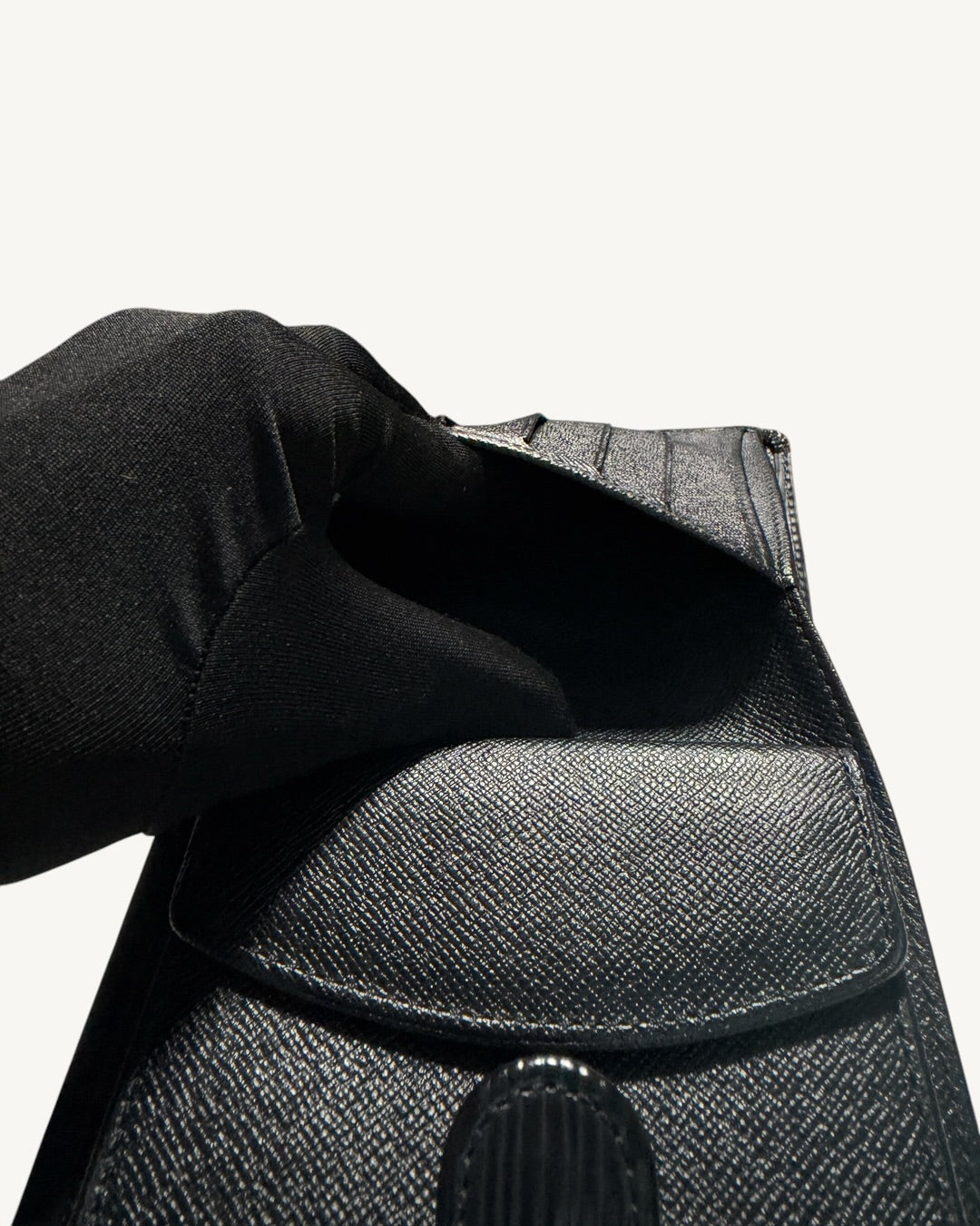 Close-up inside the open coin pocket of Louis Vuitton black leather wallet