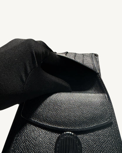 Close-up inside the open coin pocket of Louis Vuitton black leather wallet
