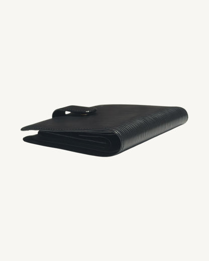 Opposite side angle of Louis Vuitton black Epi bifold wallet showing interior folds