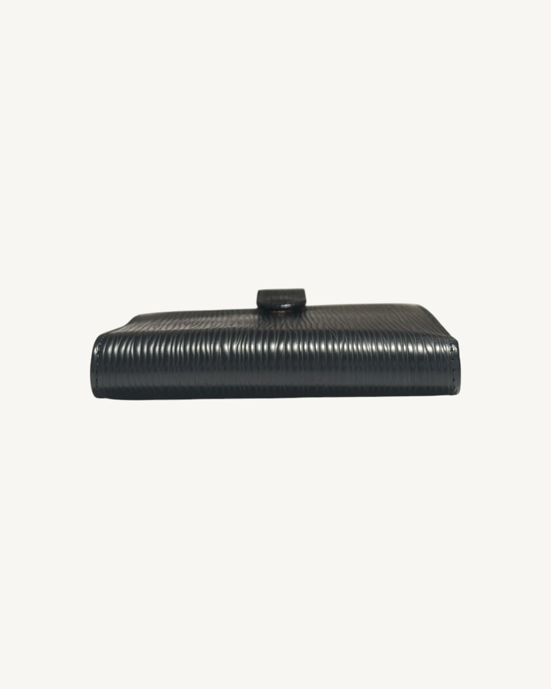 Folded spine of Louis Vuitton black Epi leather compact wallet
