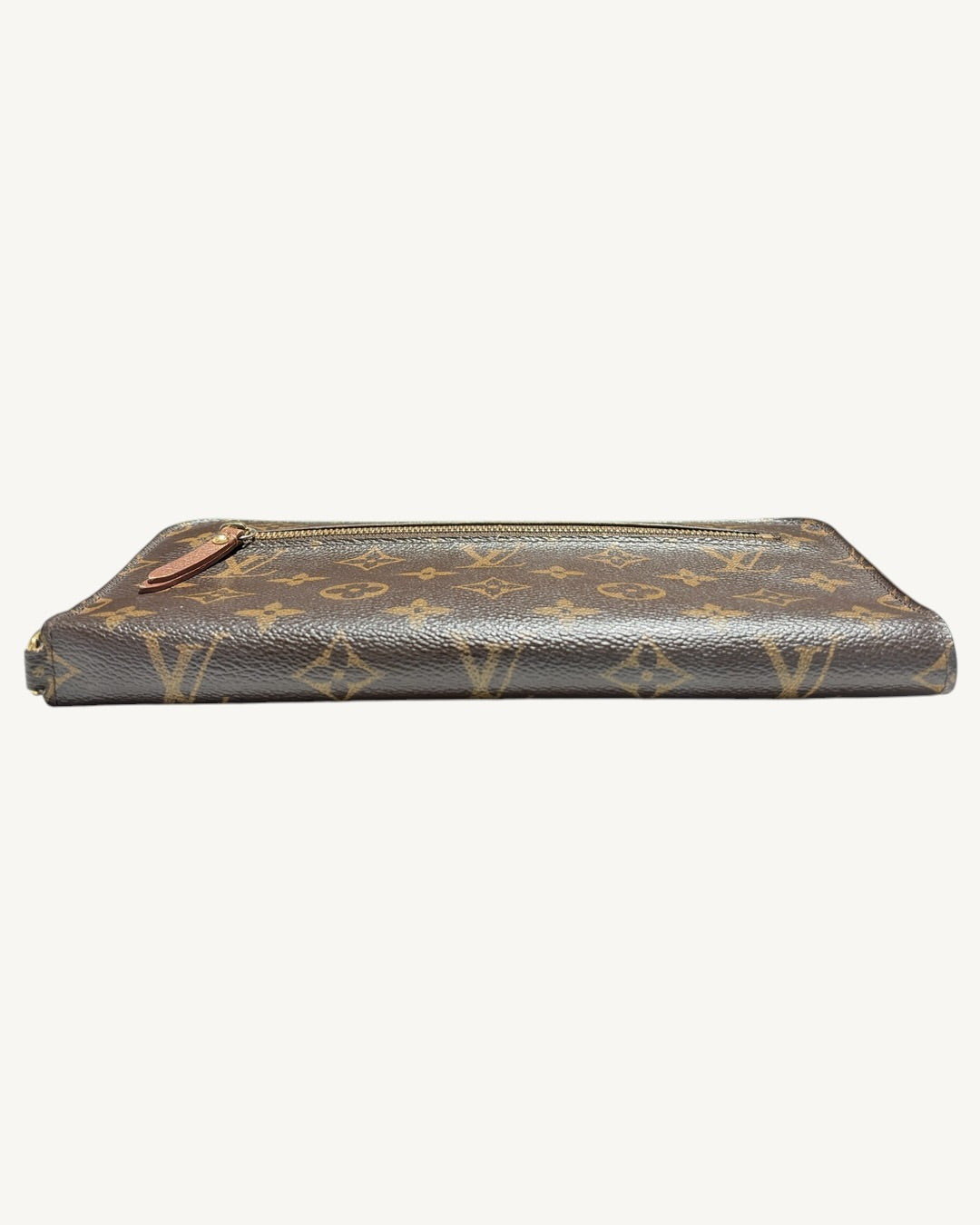 Low side view of folded Monogram wallet showing rounded spine and exterior zip pocket