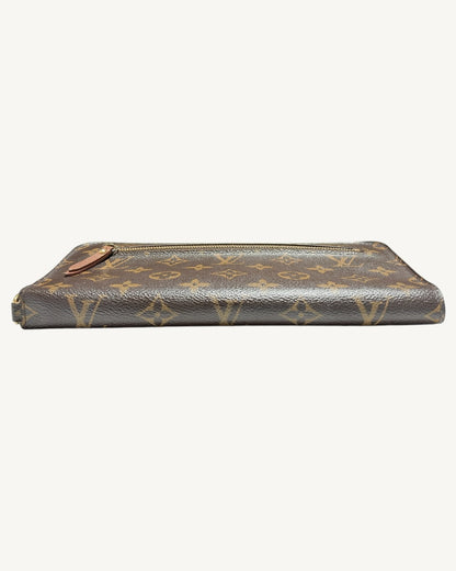Low side view of folded Monogram wallet showing rounded spine and exterior zip pocket