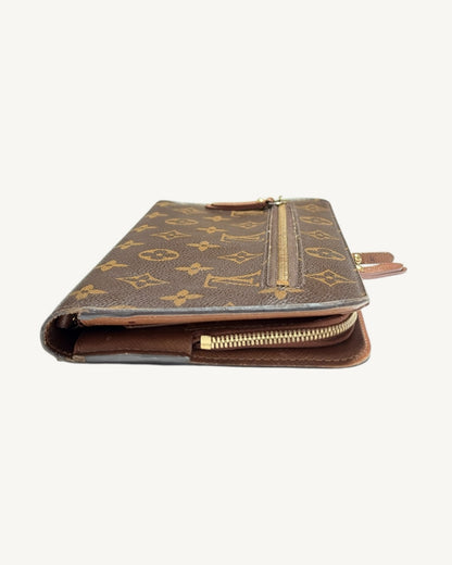 Opposite end of brown Insolite wallet showing folded canvas edge and interior zipper track