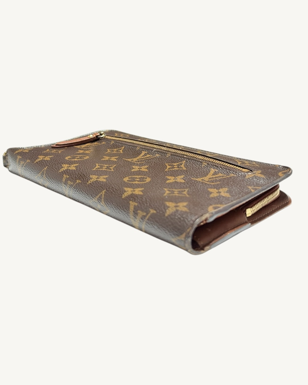 Angled view of Monogram wallet showing exterior zip pocket and folded end in the foreground