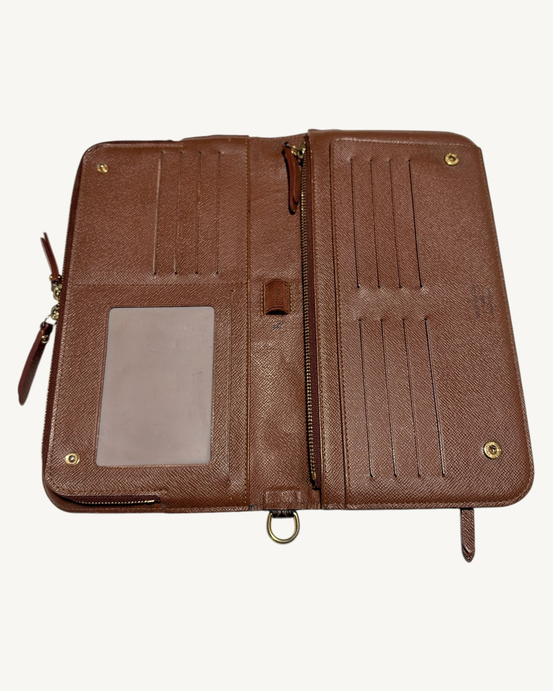 Overhead portrait view of open Louis Vuitton wallet with ID window, card slots and central zipper