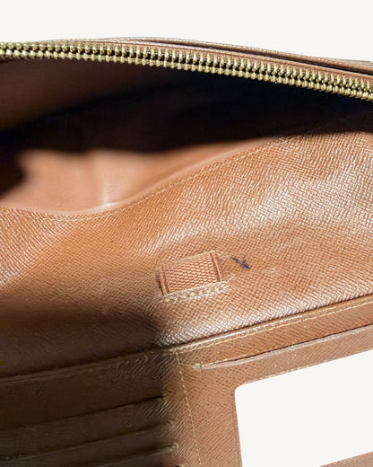 Close-up of small localized ink marks beside central pen loop with zippered pocket opened