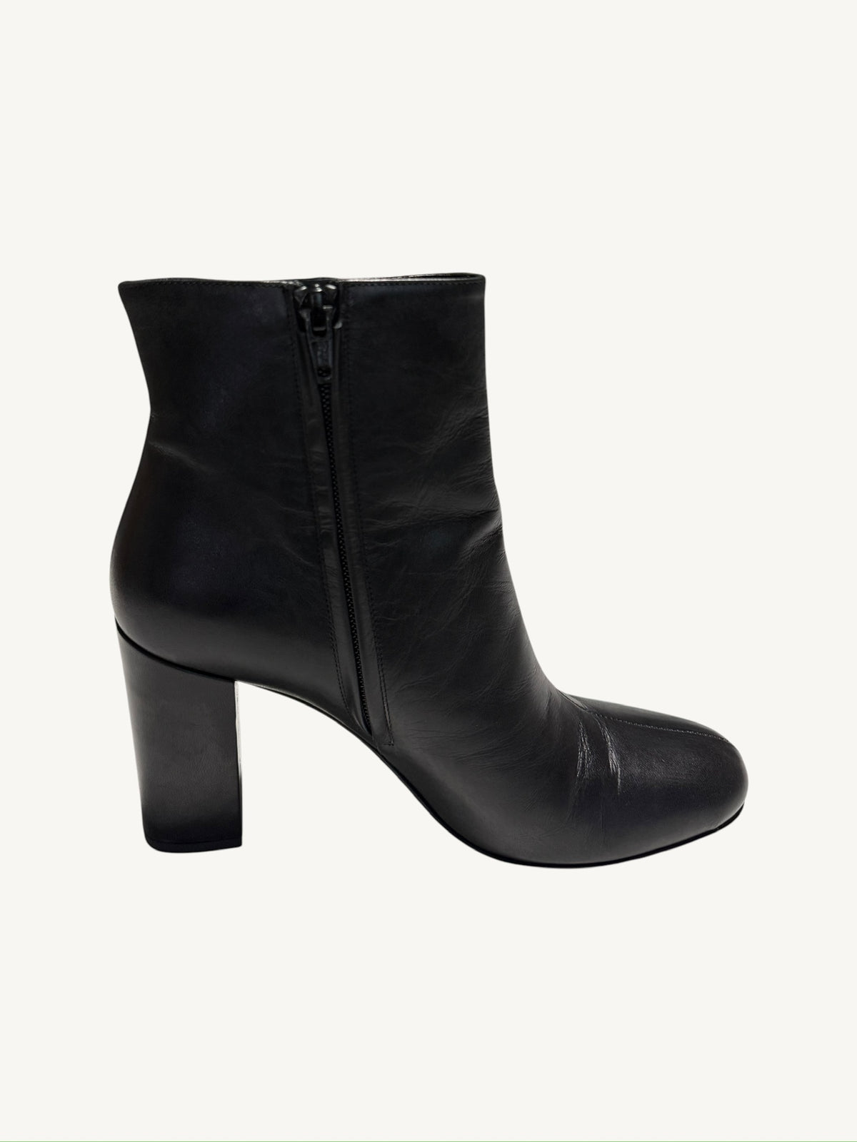 Side profile of a Saint Laurent Lou 95 black calfskin ankle boot showing the interior zipper
