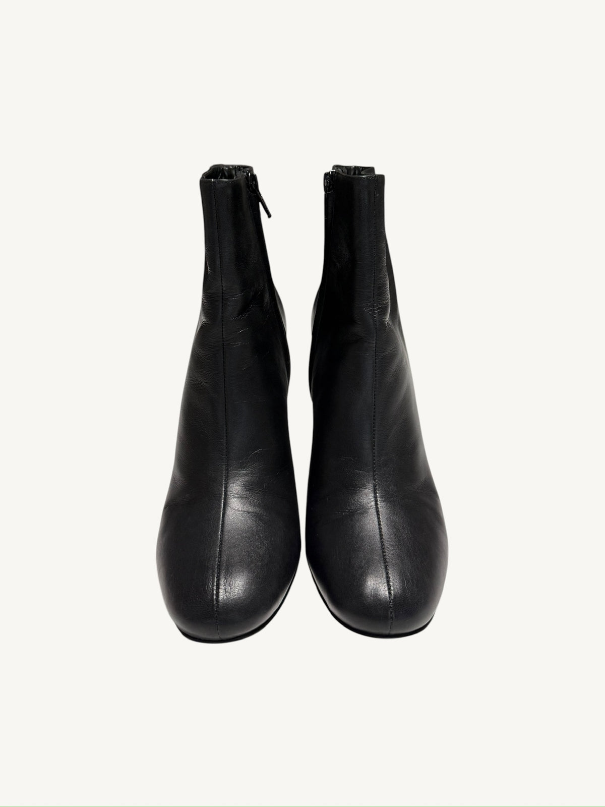 Front view of Saint Laurent Lou 95 black calfskin ankle boots showing the center seams