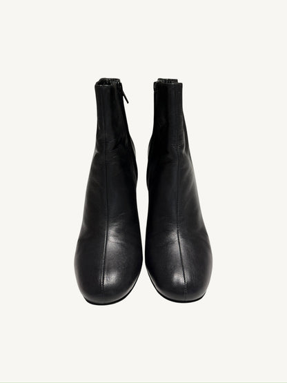 Front view of Saint Laurent Lou 95 black calfskin ankle boots showing the center seams