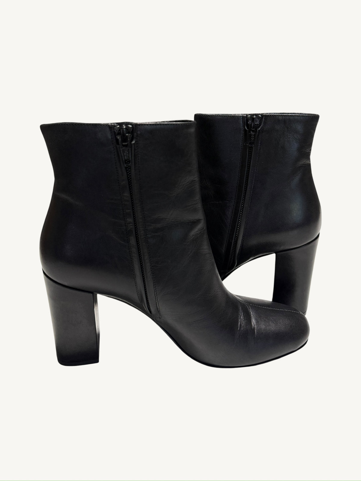 Saint Laurent Lou 95 black ankle boots showing the interior side zippers and block heels