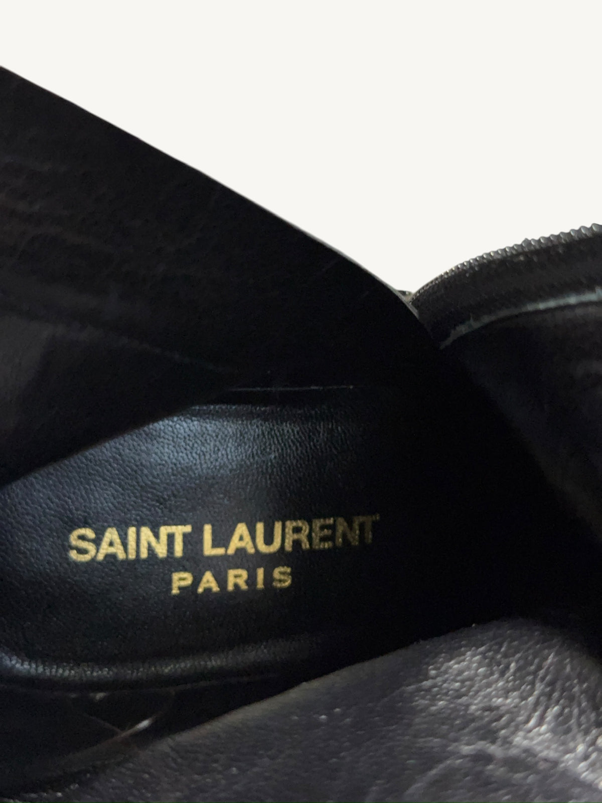 Gold Saint Laurent Paris branding inside the black leather ankle boot