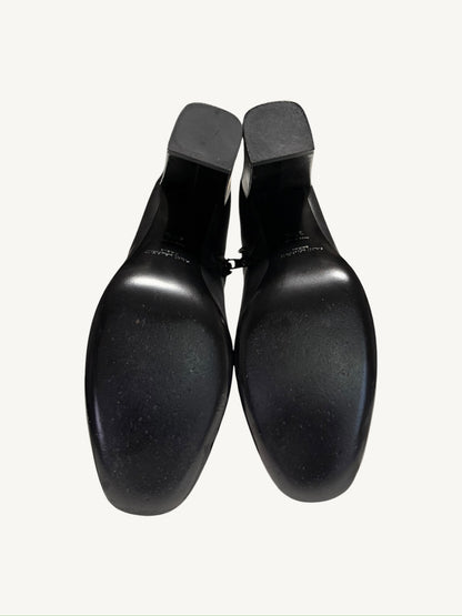 Leather outsoles and heel caps of the Saint Laurent Lou 95 black ankle boots showing wear